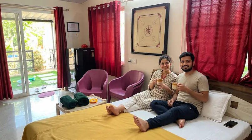 Couple relaxing in cozy bedroom of Cottage Type B at Bimal Farm