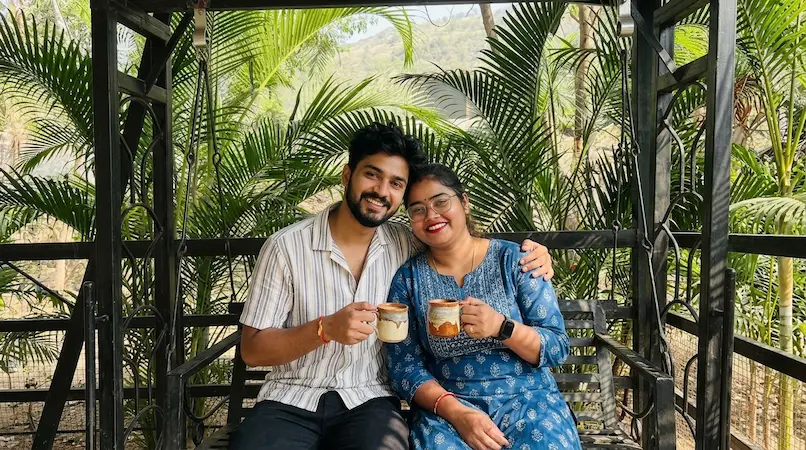 Couple enjoying morning tea on private porch jula swing at Bimal Farm